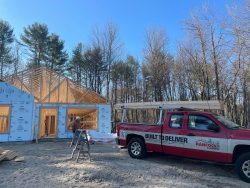 A Hancock Lumber truck is parked in front of the Saco build.