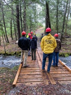 A group standing on a bridge.