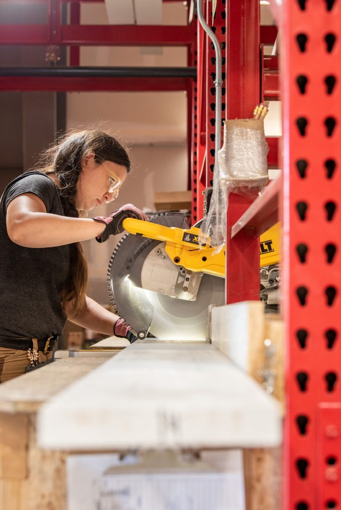 Female employee sawing